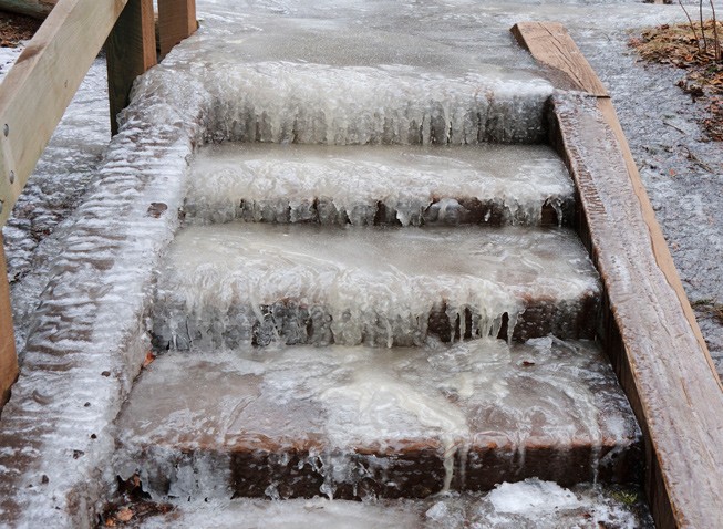 Ice-covered outdoor stairs creating a dangerous walking surface.